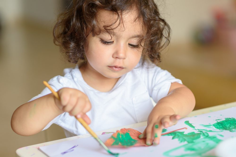 Portrait,Cute,Little,Girl,Drawing,With,Green,Paint,On,Fall